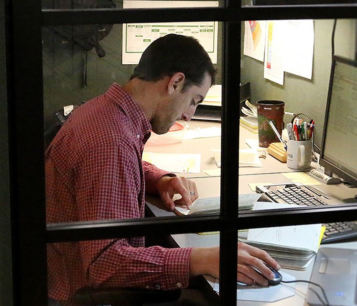 SynTerra employee working at his desk.